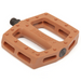 A pair of brown/copper-colored bicycle pedals with a flat platform design, featuring pin-style traction studs on the surface and cutout sections for weight reduction. The pedals are shown at an angle against a white background.