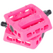Pink plastic bicycle pedal with textured grip surface and metal axle, photographed at an angle against white background